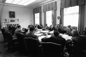 29 October 1962  Executive Committee of the National Security Council meeting. Clockwise from President Kennedy: President Kennedy; Secretary of Defense Robert S. McNamara; Deputy Secretary of Defense Roswell Gilpatric; Chairman of the Joint Chiefs of Staff  Gen. Maxwell Taylor; Assistant Secretary of Defense Paul Nitze; Deputy USIA Director Donald Wilson; Special Counsel Theodore Sorensen; Special Assistant McGeorge Bundy; Secretary of the Treasury Douglas Dillon; Attorney General Robert F. Kennedy; Vice President Lyndon B. Johnson (hidden); Ambassador Llewellyn Thompson; Arms Control and Disarmament Agency Director William C. Foster; CIA Director John McCone (hidden); Under Secretary of State George Ball; Secretary of State Dean Rusk. White House, Cabinet Room.  Photograph by Cecil Stoughton, White House, in the John F. Kennedy Presidential Library and Museum for the image. (Photo courtesy of Wiki Commons)