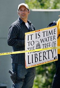 Protestor William Kostric toting a gun and a sign threatening to “water the tree of liberty.” (YouTube)